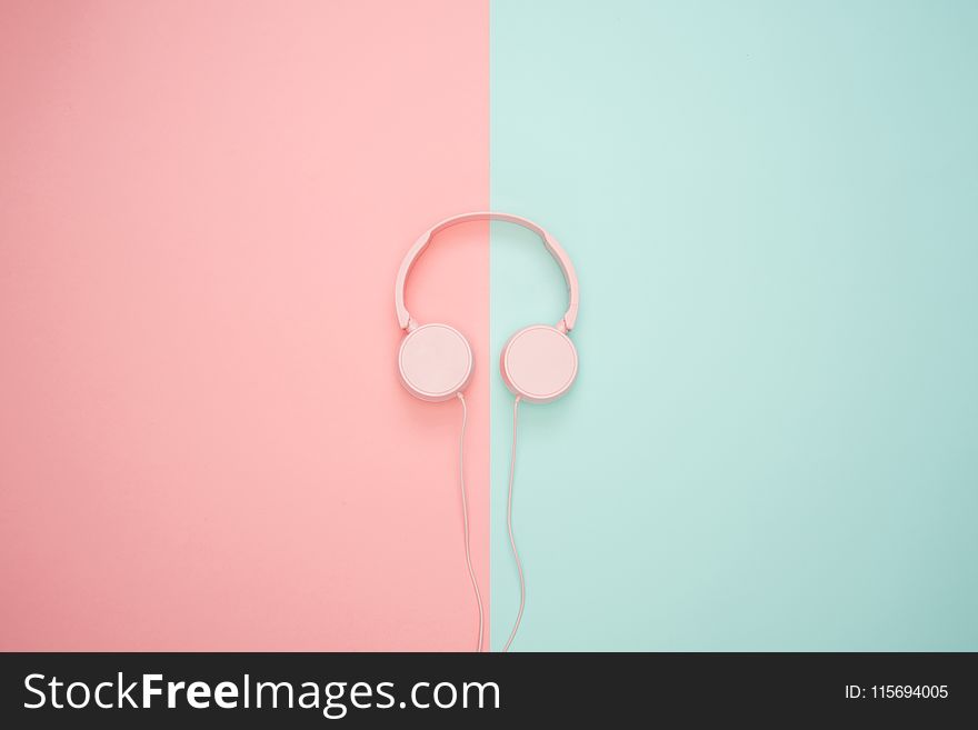 Pink Corded Headphones on pink and teal Wall