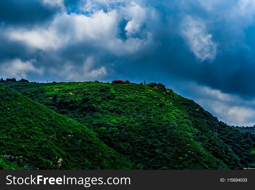 Landscape Photography of Green Mountain Under Cloudy Sky
