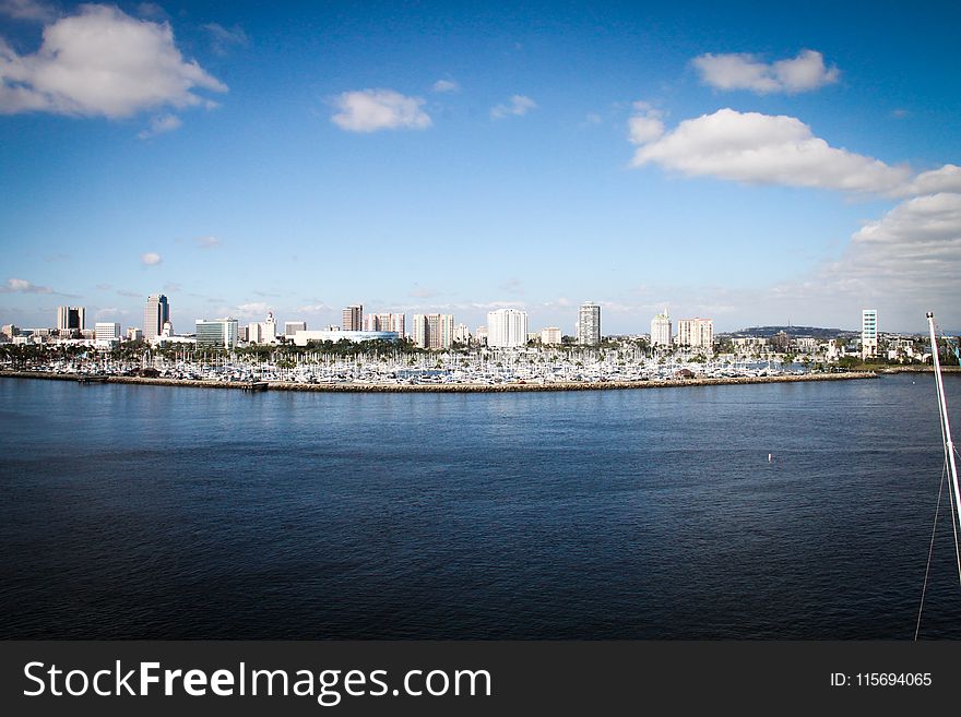 Body Of Water With Buildings On Side