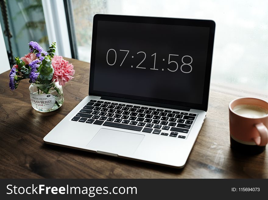 Silver Macbook Pro Displaying 7:21:58