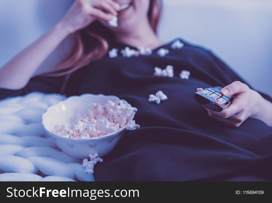 Woman Wearing Black Dress Shirt Eating Popcorn