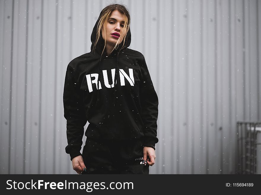 Woman Wearing Black and White Run-printed Pullover Hoodie