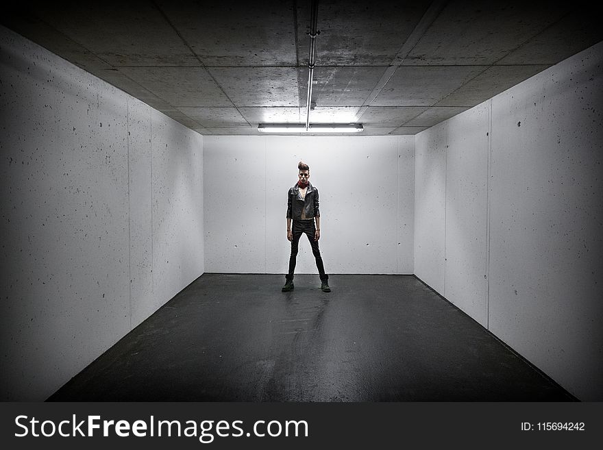 Person Standing Inside White Wall Box Room