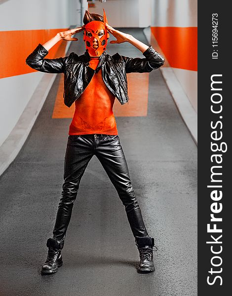 Man In Black Leather Jacket And Pants Wearing Orange Mask