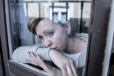 Young Attractive Unhappy Depressed Lonely Woman Looking Sad Looking Through The Window At Home Stock Image
