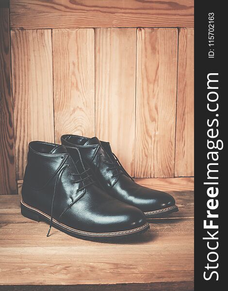 Men’s footwear on the wooden background.