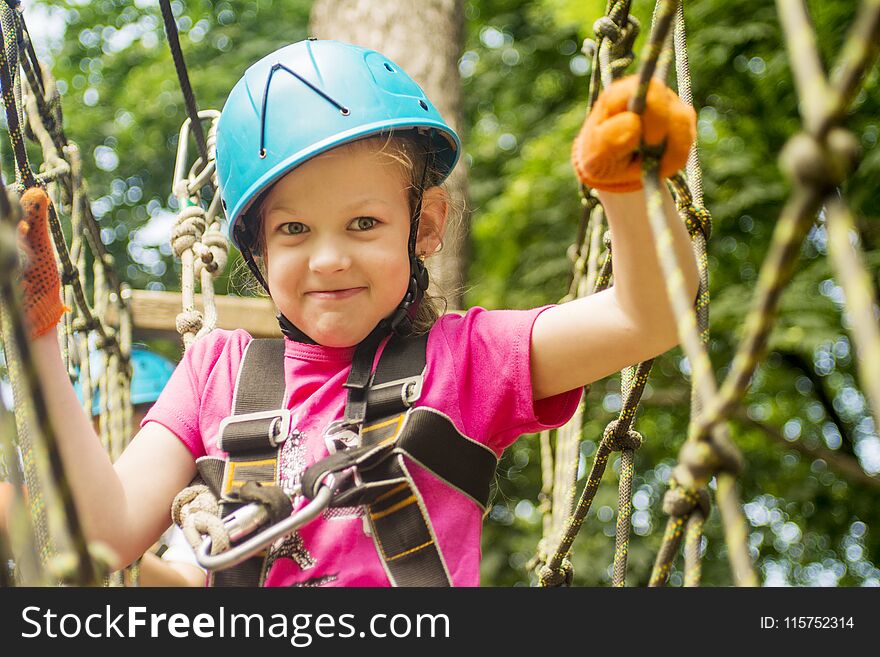 Five year girl on rope-way in the forest