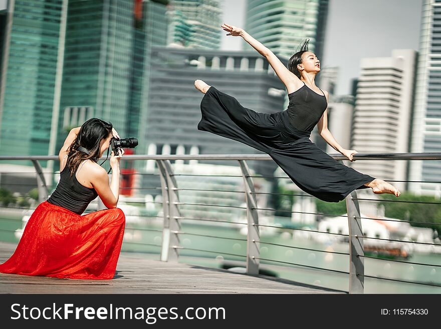 Two Beautiful Young Girls Having Fun Photo Shooting On A Deck Wi