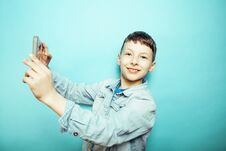 Little Cute Boy Posing Emotional On Blue Background With Smartph Stock Photography