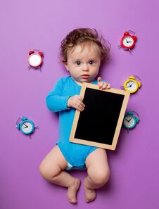 Baby With Alarm Clock And Blackboard Stock Photos Baby With Alarm Clock And Blackboard Stock Photos