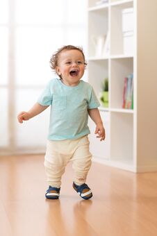 Little Boy Running And Laughing In Ther Living Room Stock Image