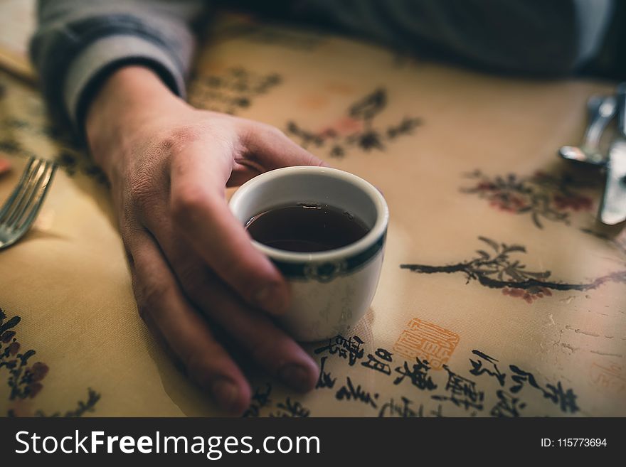 Person Holding White Ceramic Mug