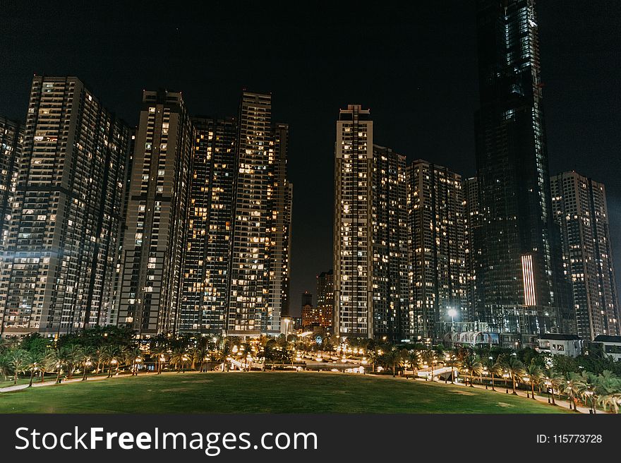 Lightened High Rise Buildings At Night Time