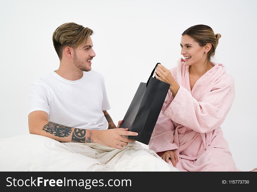 Man and Woman Holding Black Tote Bag