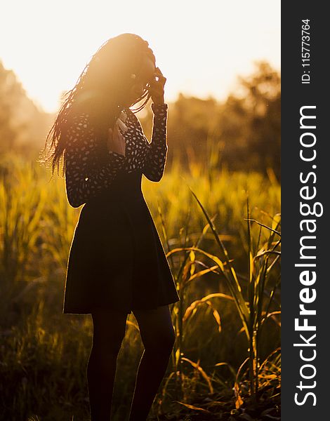 Woman Wearing Black Dress During Sunset