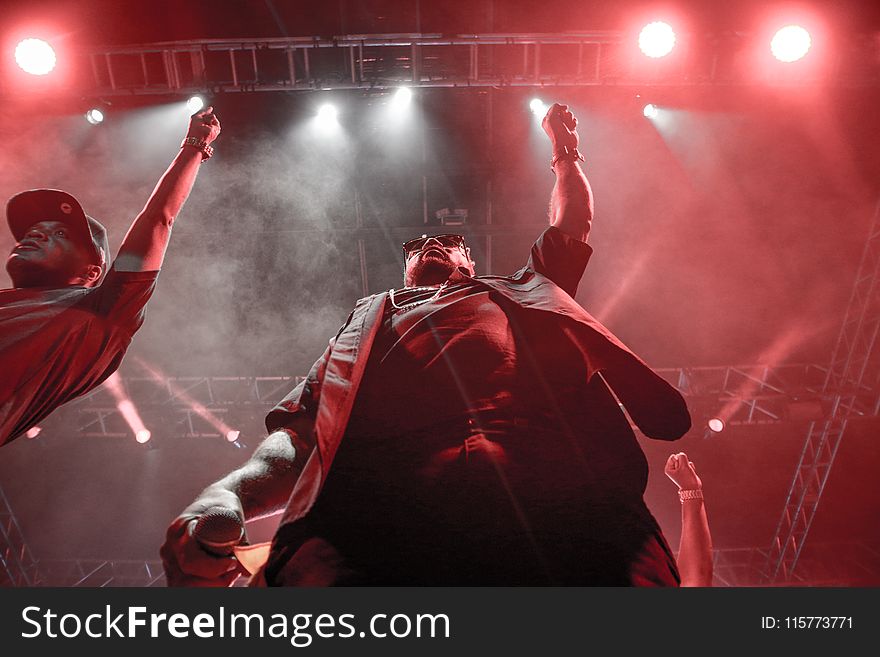 Two Men Standing Raising Right Hands