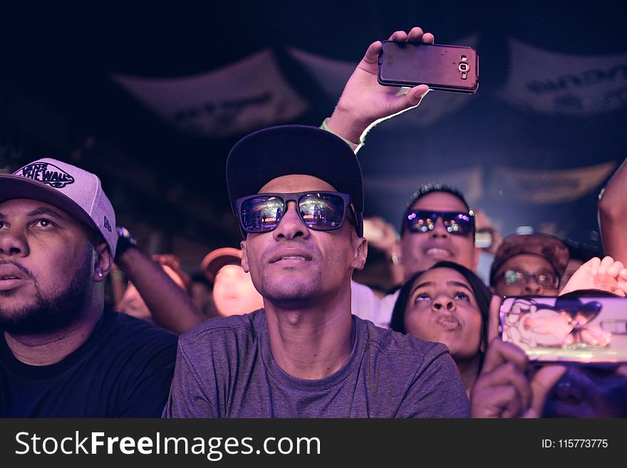 Man Wearing Black Sunglasses Sitting Next To Man