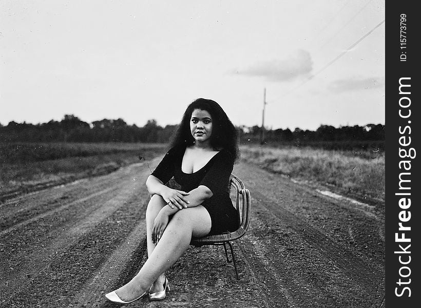 Grayscale Photography of Woman Sitting on Chair