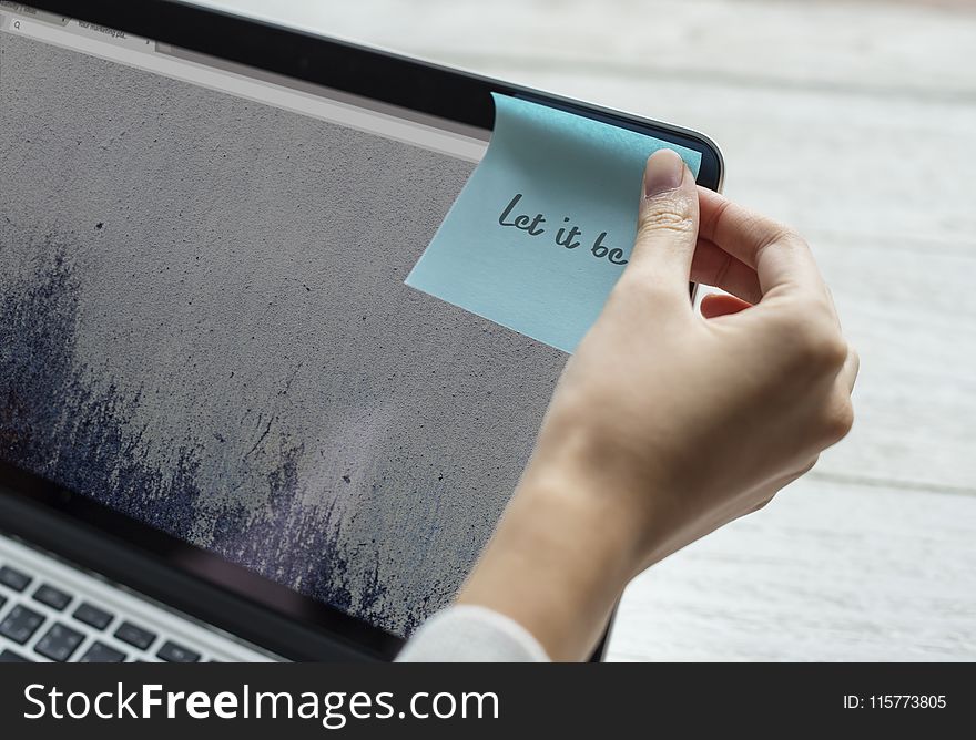 Person Holding Blue Sticky Note