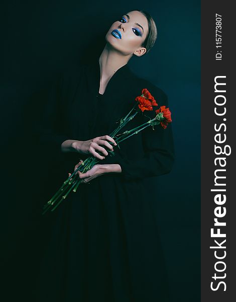 Woman In Black Long-sleeved Dress Holding Red Flowers