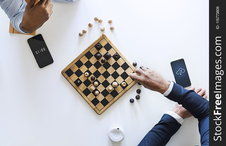 Flat Lay Photography of Two Men Playing Chess