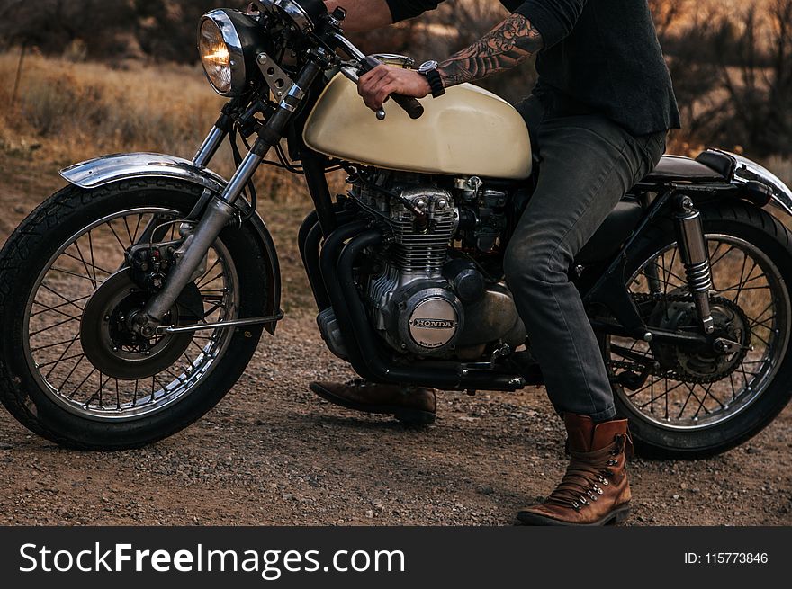 Man Riding Beige Naked Motorcycle