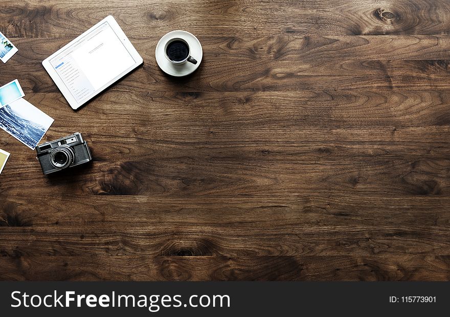 Camera Near The Cup Of Coffee