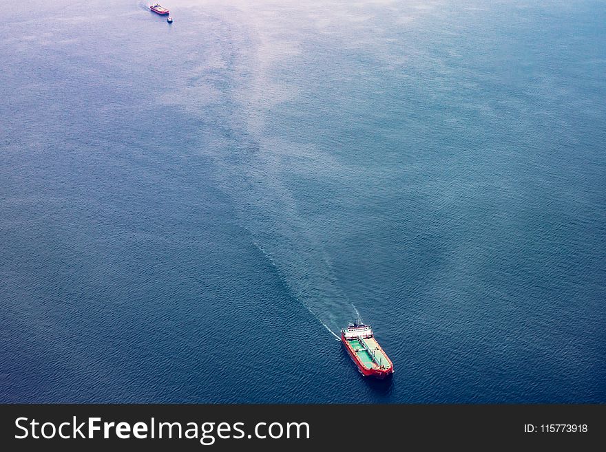 Red, White, and Teal Cargo Ship on Water