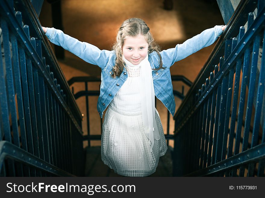 Girl Wearing White Dress and Blue Denim Jacket Standing on Stairs