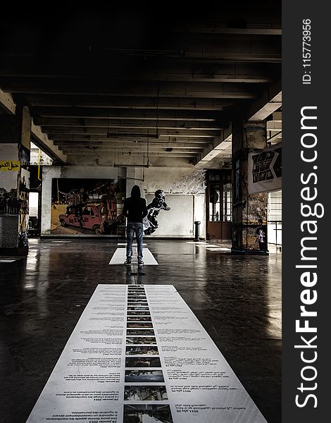 Person Standing On Ceramic Floor Tiles