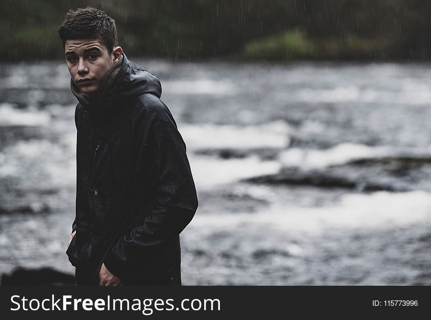 Man Wearing Black Rain Coat