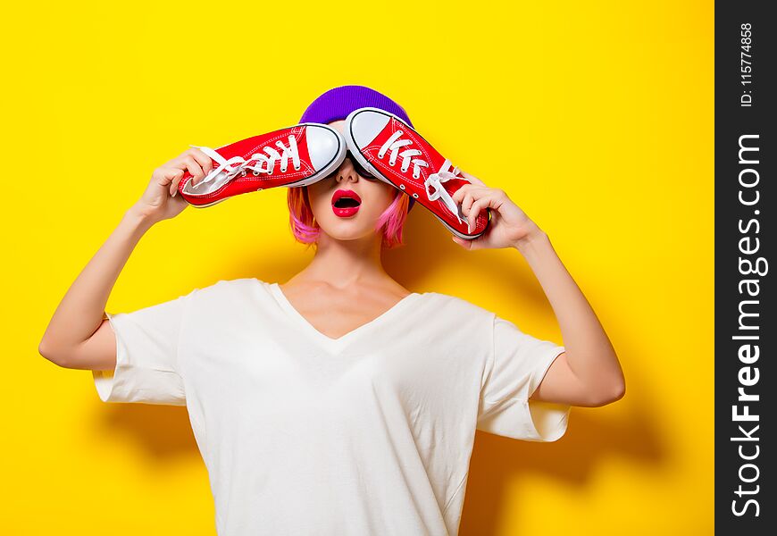 Girl With Pink Hair Holding A Red Gumshoes