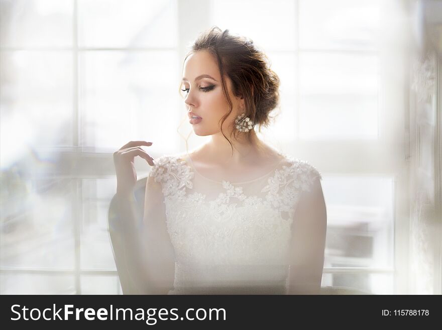 Young Beautiful Brunette Woman With Bouquet Posing In A Wedding