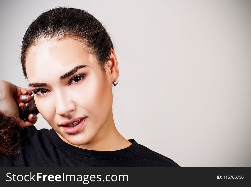 Portrait of beautiful woman with vitiligo in black t-shirt. Over gray background.