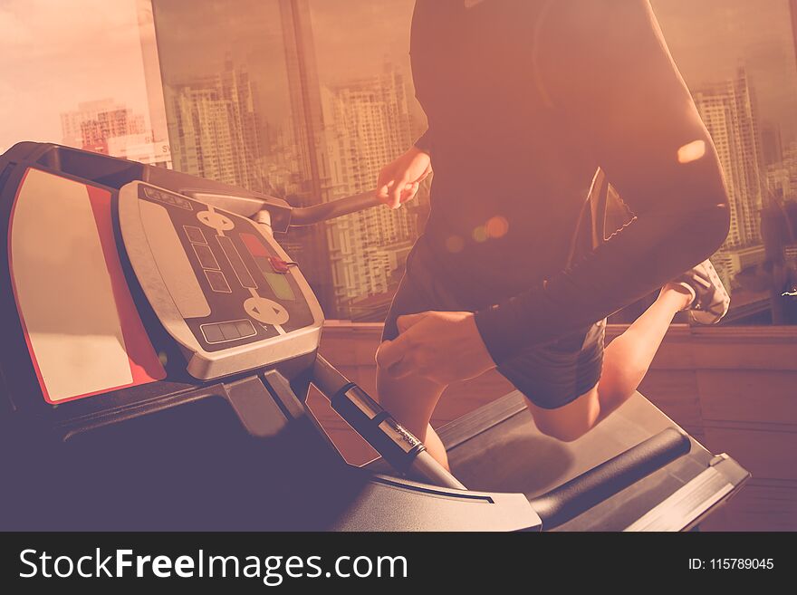 Man running in a gym on a treadmill. Man running in a gym on a treadmill