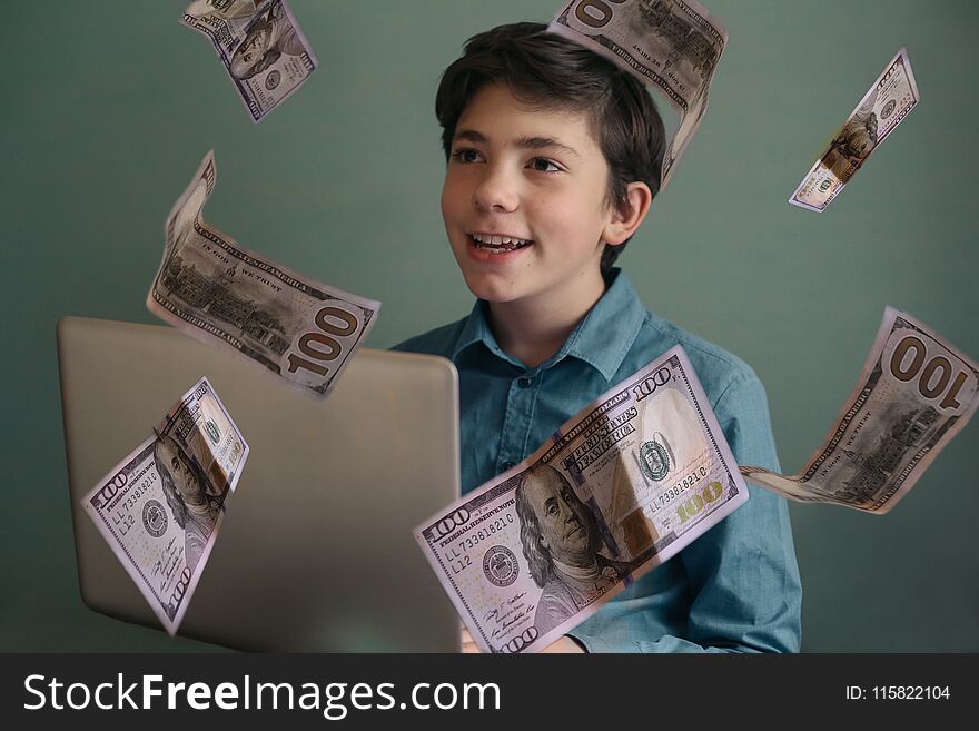 Talented successful ambitious teenager boy with laptop freelance working earn money on internet