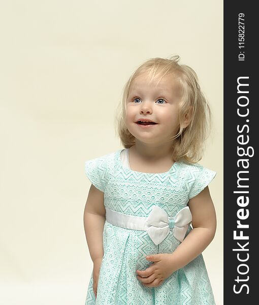 Portrait of a cheerful child with a big smile and a cute blue dress. Portrait of a cheerful child with a big smile and a cute blue dress