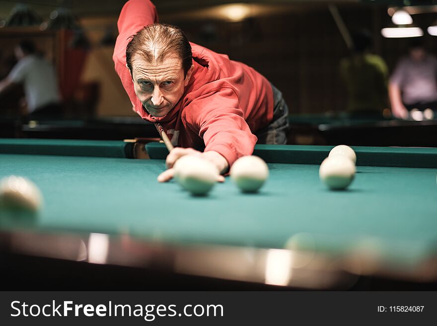 A Pool Player Takes Aim At The Ball