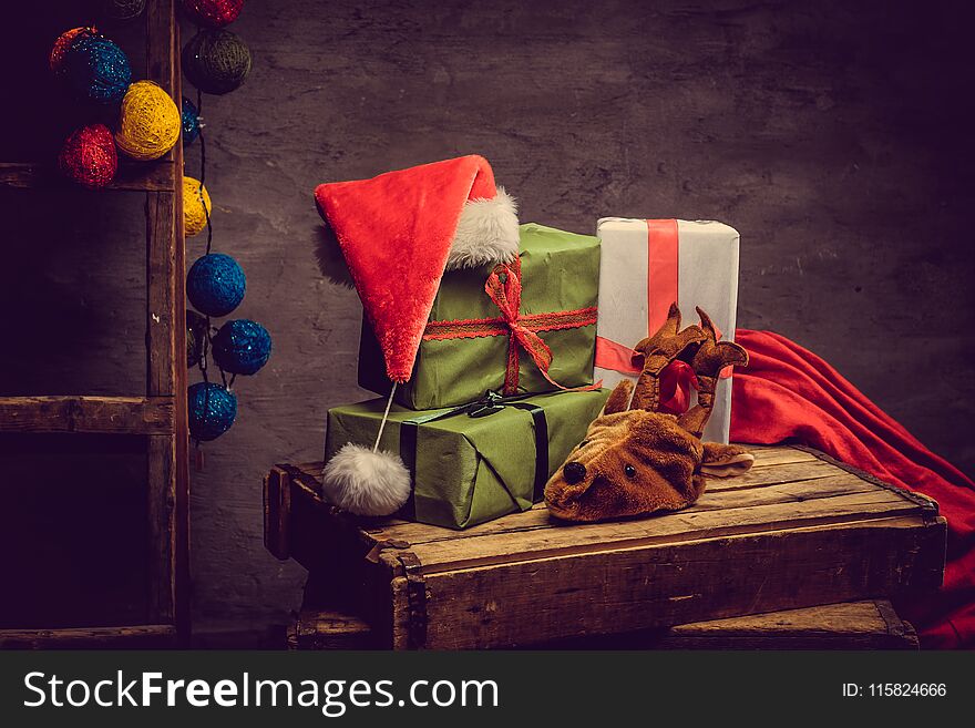 Christmas decoration with Santa`s hat, glare balls and gift boxes. Christmas decoration with Santa`s hat, glare balls and gift boxes.