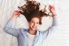 Beautiful Smiling Young Red Hair Woman Laying In Bed Royalty Free Stock Image