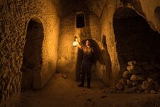 Man With Kerosene Lamp Explores Ancient Abandoned Underground Chalky Cave Temple Royalty Free Stock Photos