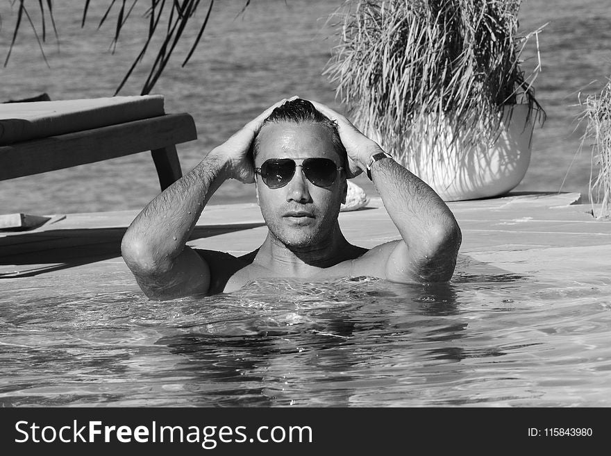 Grayscale Photo Of Man In Swimming Pool