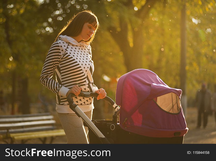 Woman Holding Pink And Black Stroller