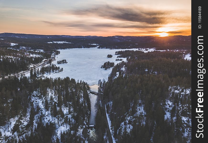 Aerial Photo Of Snowy Forest During Sunset