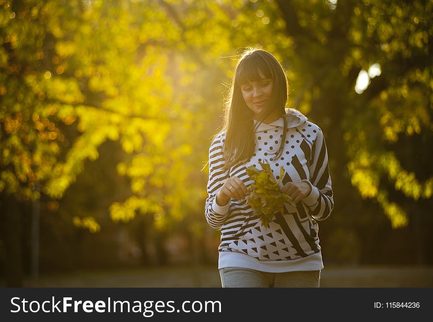 Woman Holding Leaves