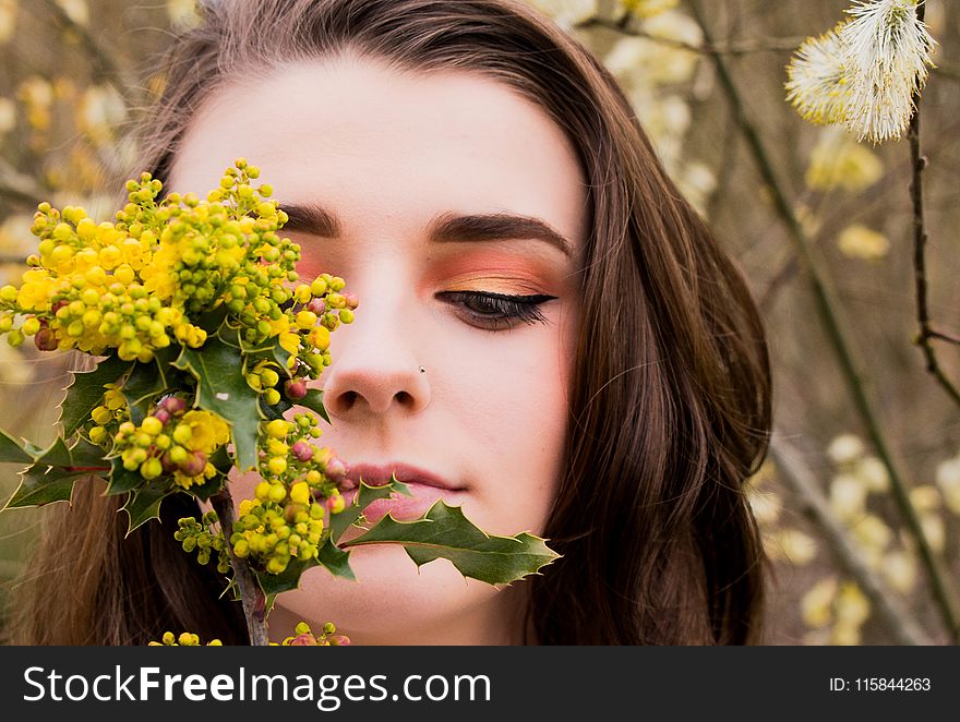 Woman Looking at a Green and Yellow Leafed Plant