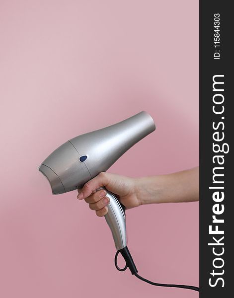 Person Holding Grey Hair Dryer