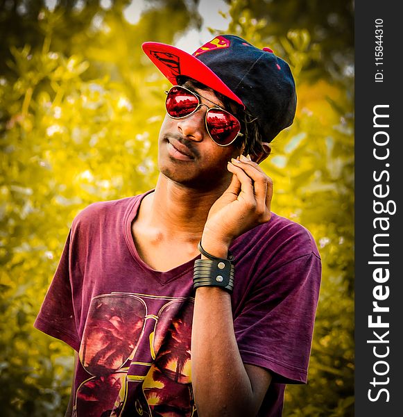 Man Wearing Red And Black Fitted Cap And Purple Crew-neck T-shirt Photo