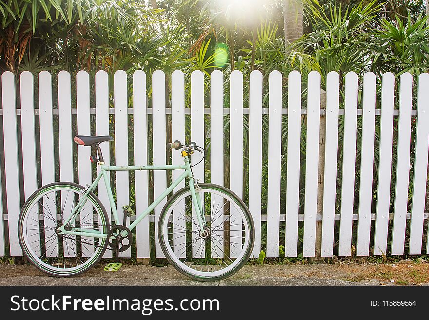 Bicycle and wooden fence, which as the background.