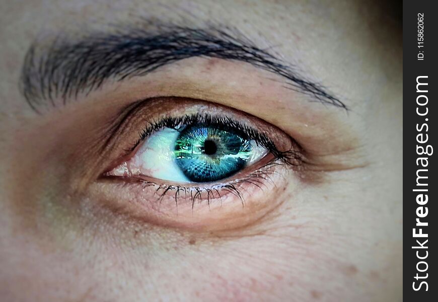 Close up photo of a deep blue eye of a woman